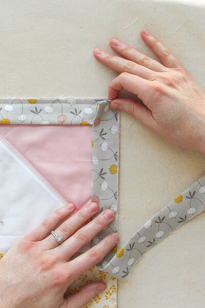How to Bind a Quilt With Mitered Corners | Written Guide 6 Fold the Mitered Corner Binding Strip Over Itself by Villageboundquilts