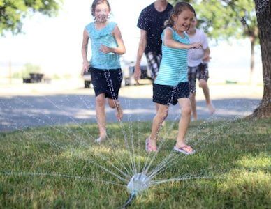Soda Bottle DIY Sprinklers for Kids by Gluesticks Blog