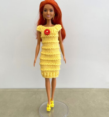 Knitting pattern for an easy to knit dress for Barbie by Purlspatterns